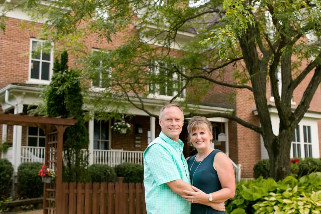 Kirk and Wendy Stensrud- owners of the Round Barn Farm Wedding venue and Bed and Breakfast stand in front of the B&B.