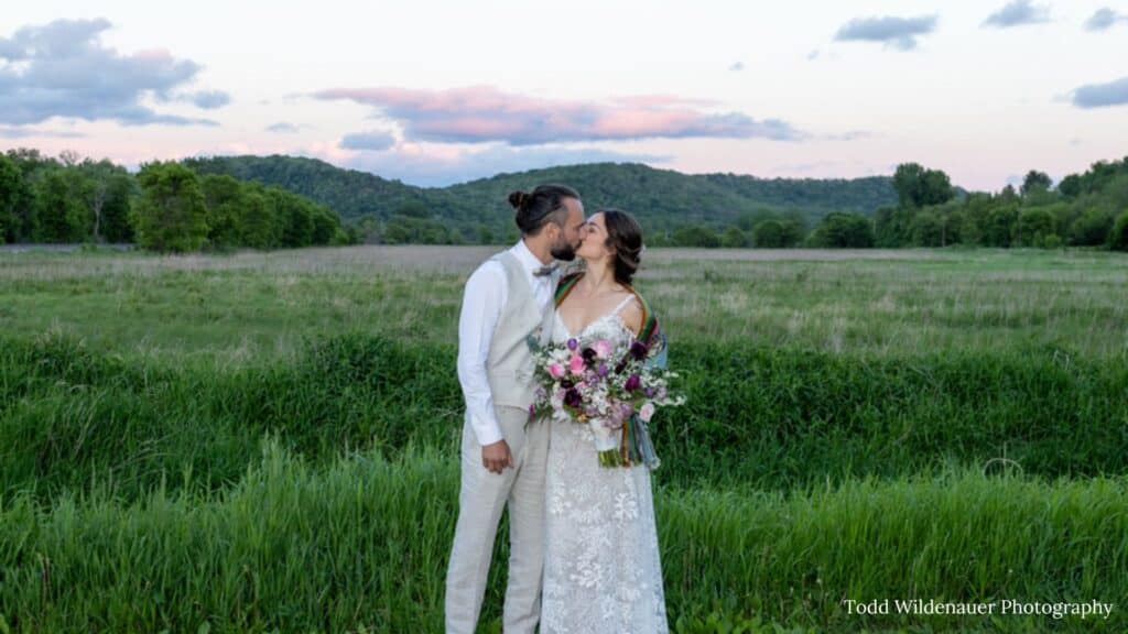 Stunning spots at the round barn farm in Red Wing, Minnesota for your wedding photos. Gorgeous Sunset views of the bluffs make the perfect golden hour wedding photos. Red Wing, Minnesota best wedding venues. 