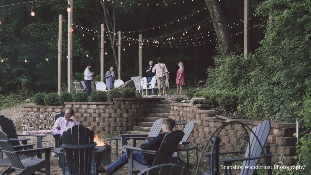 Wedding guests enjoying the bonfire at Round Barn Farm in Red Wing, Minnesota. 