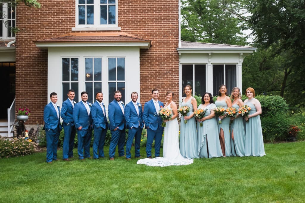 Wedding party in front of the Round Barn Farm Bed and Breakfast for wedding photographs. One of the Best Minnesota Wedding Venues with lodging.