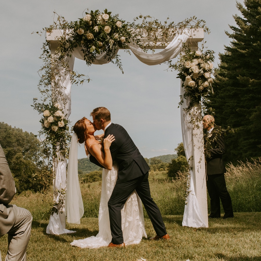 Playing a round of golf at the top Red Wing Golf Courses is a great way to have some fun before your wedding at Round Barn Farm - one of the best wedding venues in Red Wing, MN. Pictured here is a couple getting married on our scenic outdoor farm.