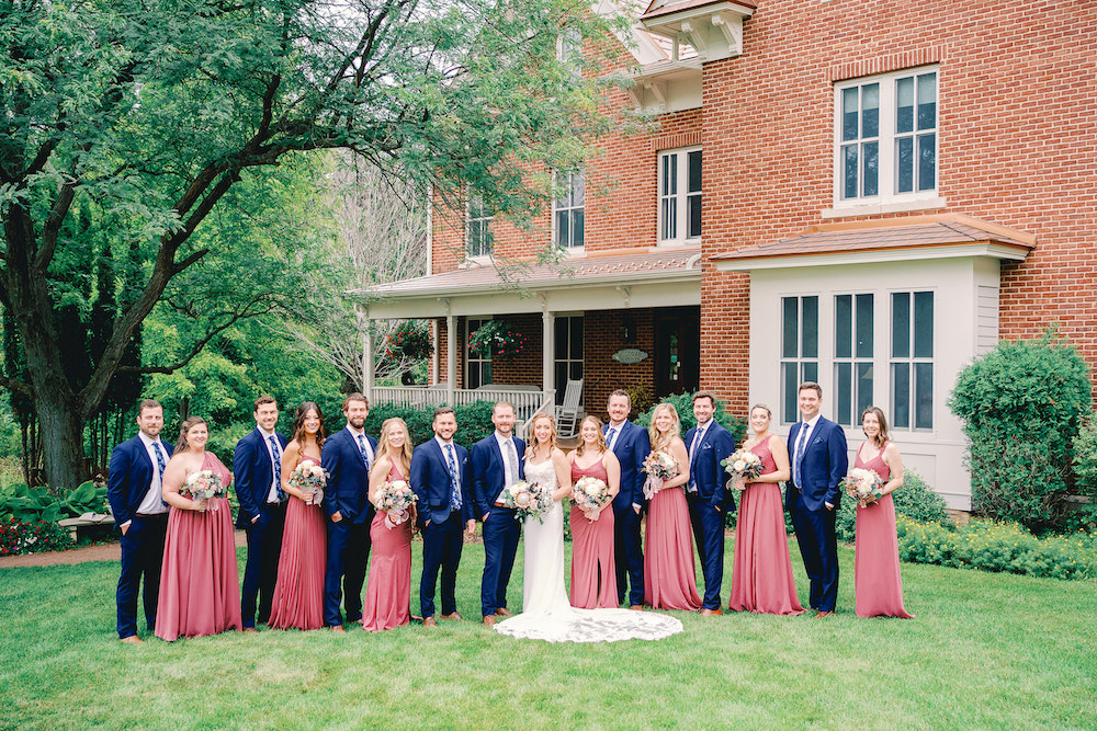 A wedding party in front of the Inn at one of the best Minnesota wedding venues in Red Wing, MN
