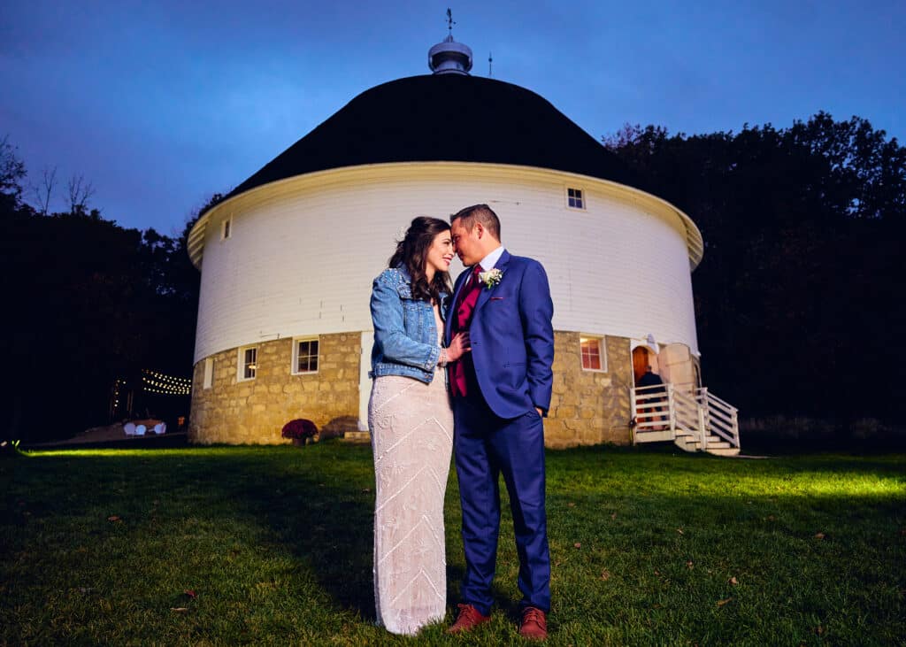 One of the Most Unique Wedding Venues in Minnesota 8 Happy Couple outside the Round barn in the evening after their wedding and reception at one of the most unique wedding venues in Minnesota.