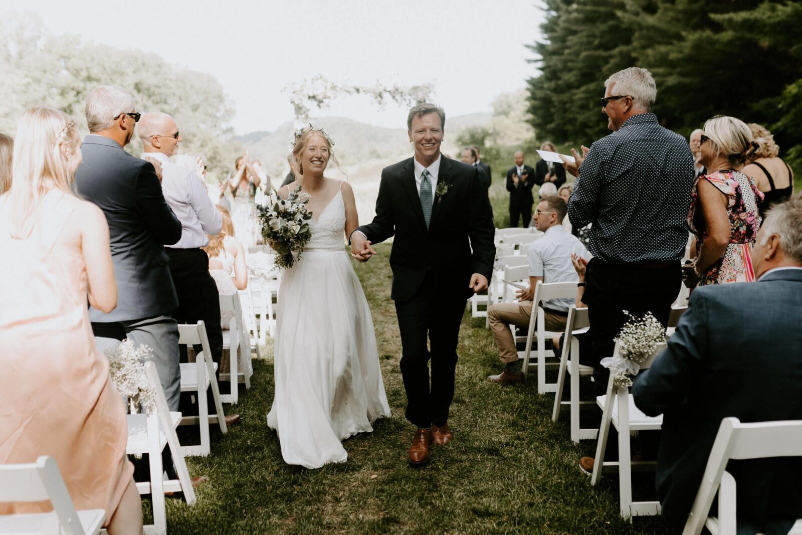 What's Unique about Bed and Breakfast Wedding Venues 2 Couple walking down aisle after ceremony at our Bed Breakfast wedding venue.