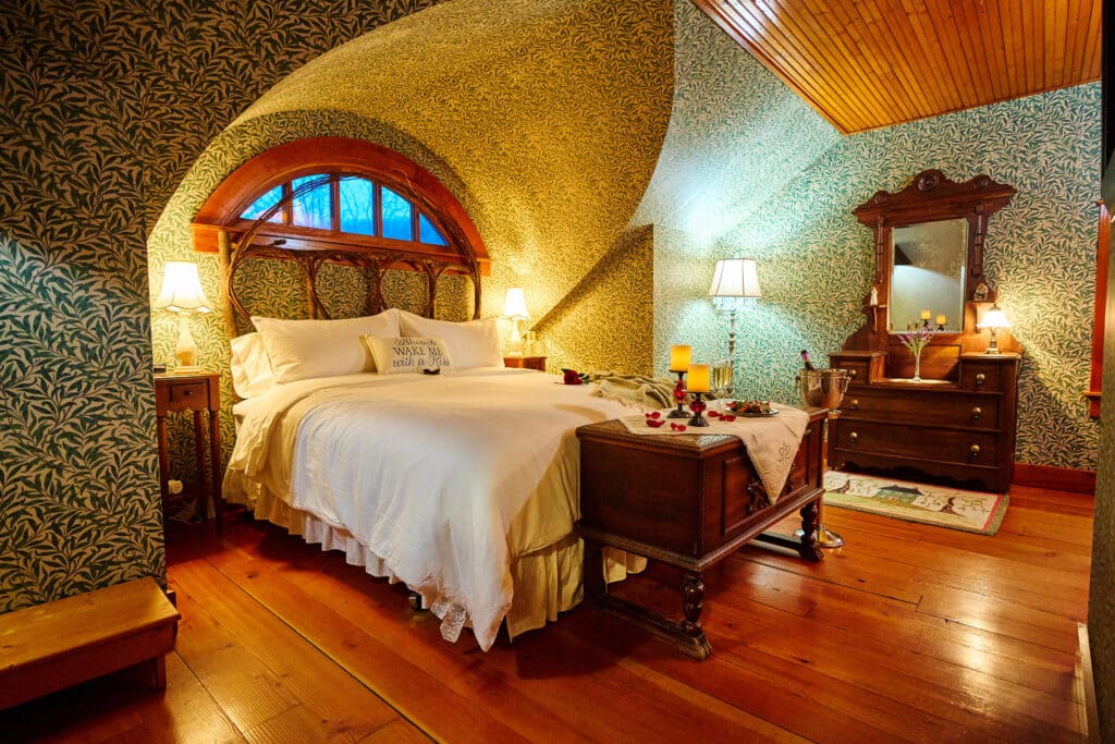 The Most Romantic Getaways in MN Start Here 7 Bed, dresser, and green William Morris wall paper in The Willow Suite at our Red Wing Bed and Breakfast.