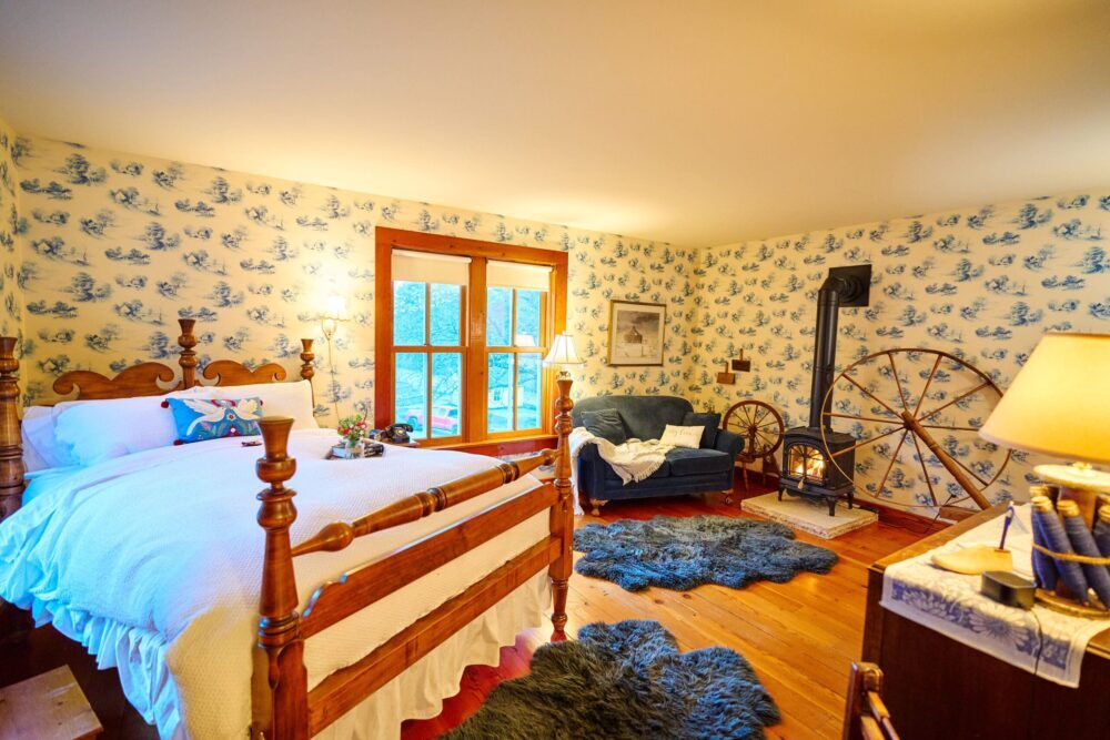The Spinning Suite has a cozy sitting area with gas stove and queen bed.