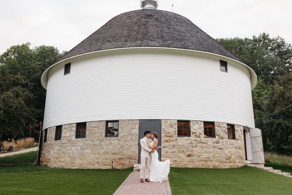 Couple in front of our historic round barn, one of the most unique places to get married in MN.
