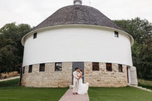 Couple in front of our historic round barn, one of the most unique places to get married in MN.