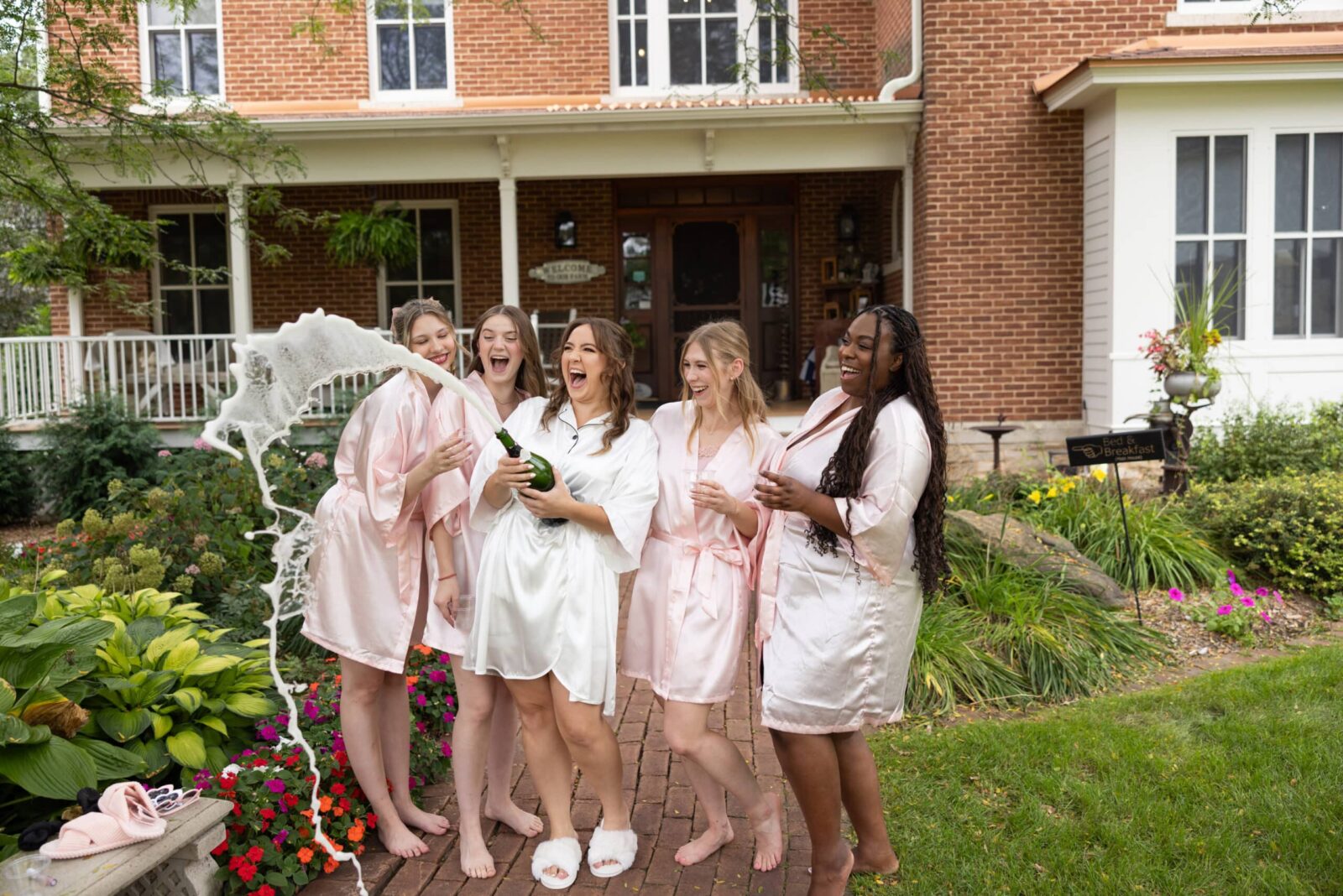 Unique Places to Get Married in Minnesota 2 Bride and her attendants pop the champagne before getting ready onsite at our unique wedding venue in Red Wing MN.