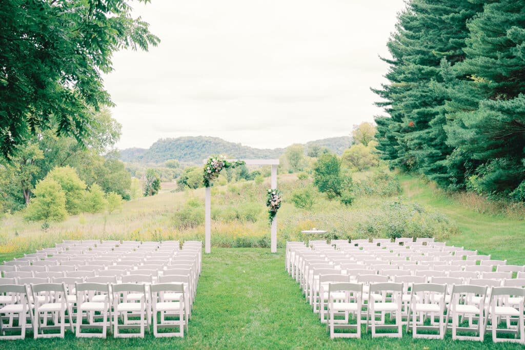 Outdoor wedding ceremony area set up with arch and chairs at our Southern Minnesota wedding venues.