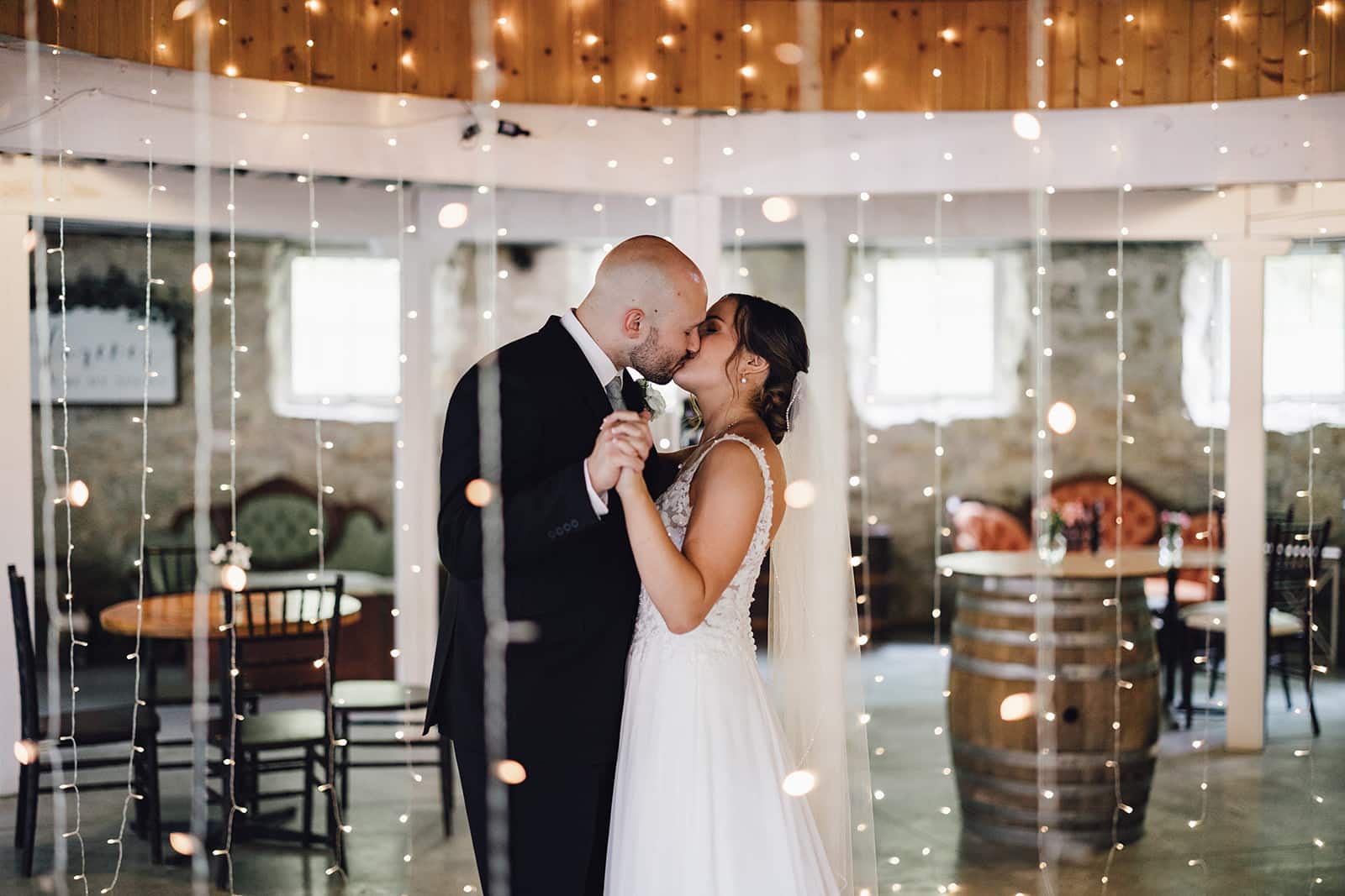 How Long Does It Take to Plan a Wedding? 2 Bride and Groom take their first dance in historic round barn at our Minnesota wedding venue.