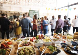 Buffet dinner and people at wedding rehearsal dinner venues